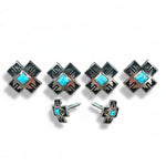 a collection of silver-colored metal cross-shaped buttons with turquoise stones set in them.