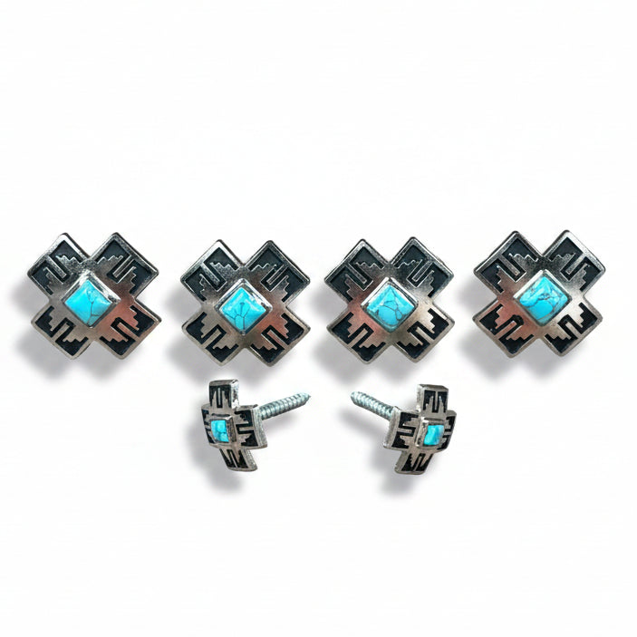 a collection of silver-colored metal cross-shaped buttons with turquoise stones set in them.