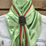 a green scarf with a black buckle on it