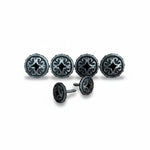 a collection of ornate, black metal knobs or buttons with intricate designs, arranged in a row.