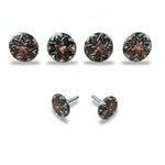a collection of six round metal buttons with star-shaped designs, arranged in two rows of three.