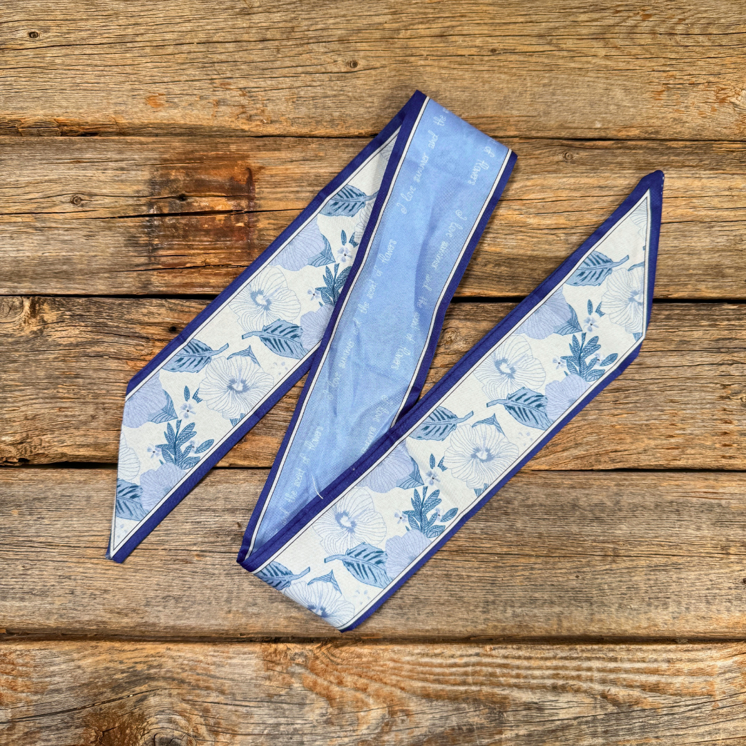 a blue and white patterned scarf or bandana lying on a wooden surface.