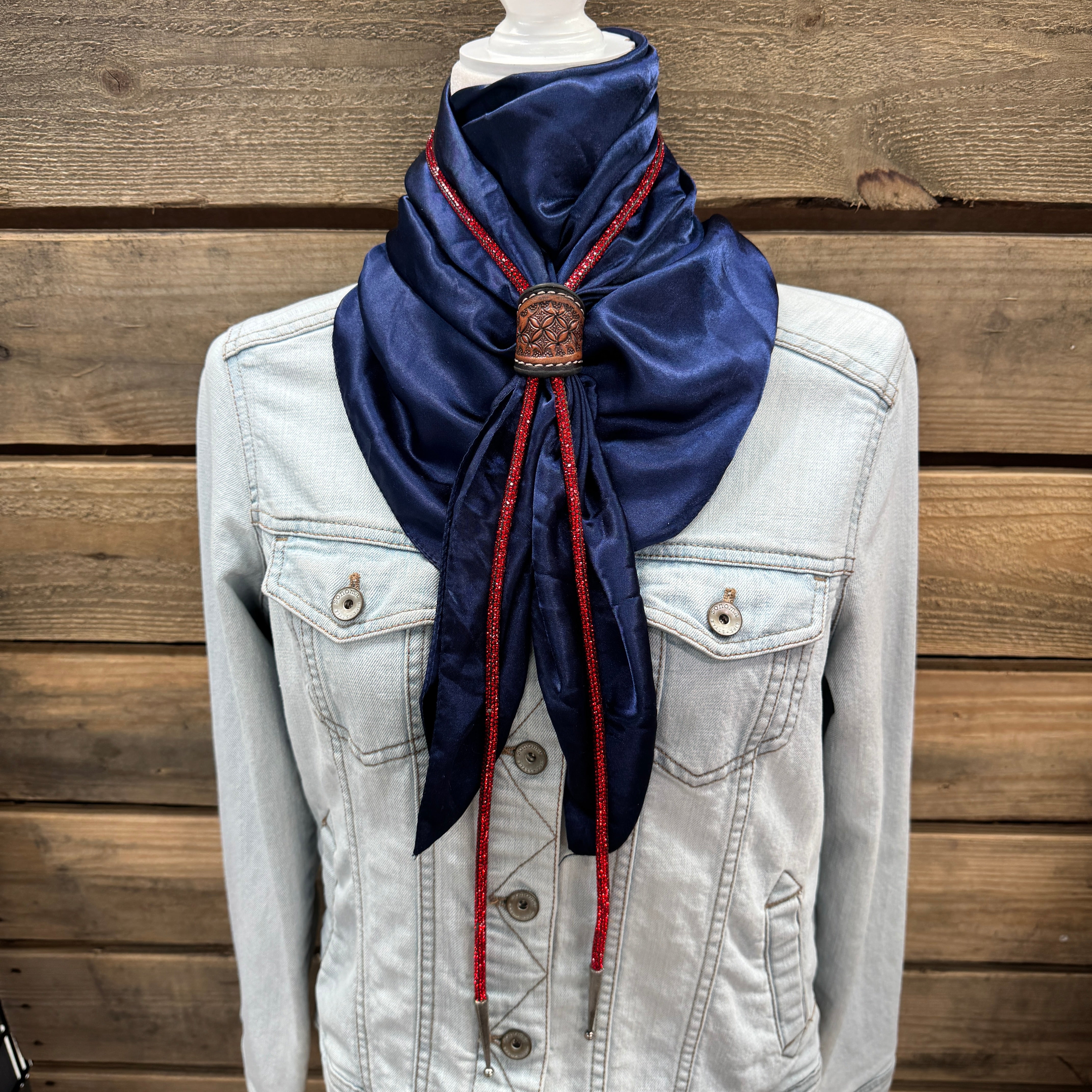 a white jacket and a blue scarf on a mannequin