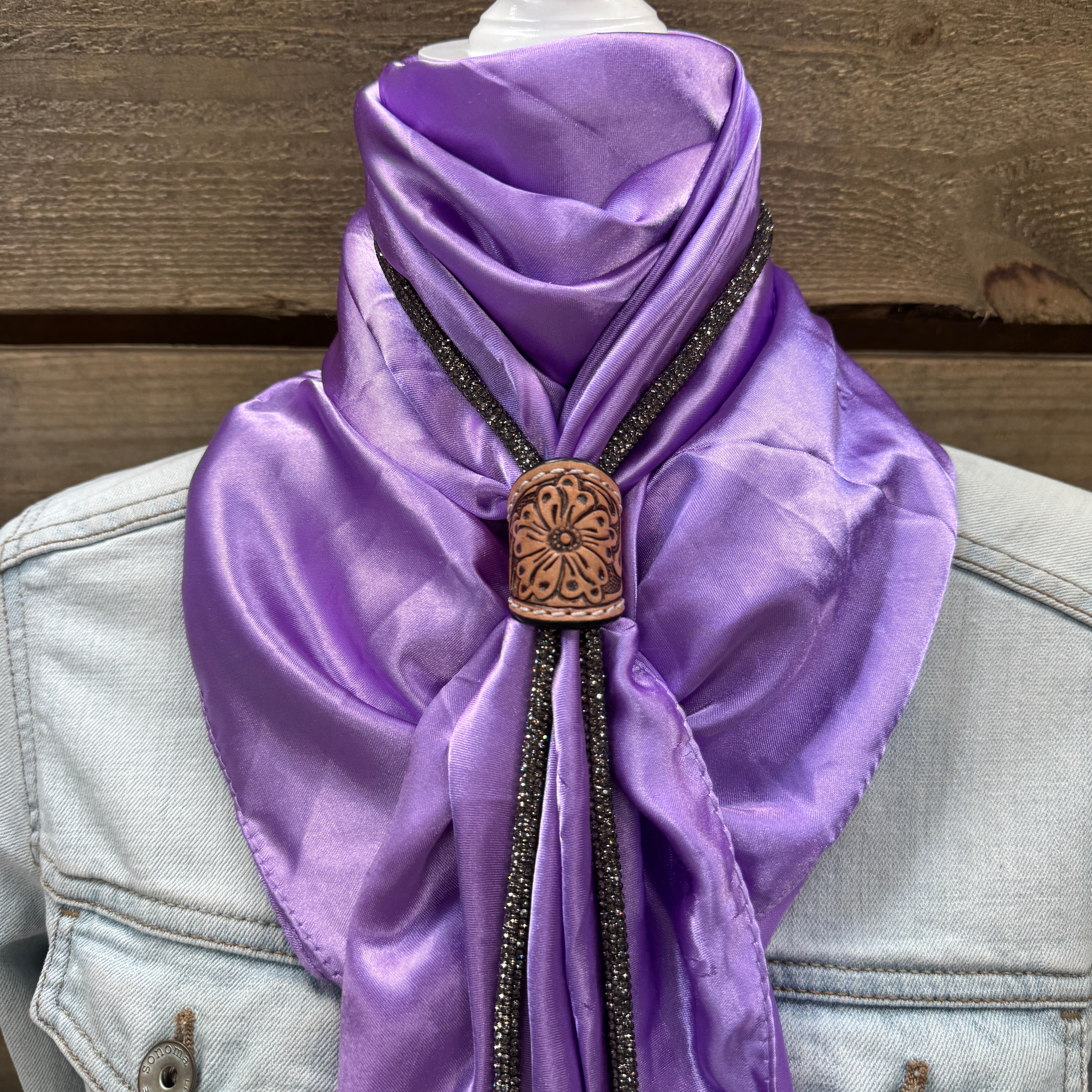 a purple scarf with a wooden button on it