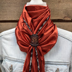 a woman wearing a red scarf and a denim jacket