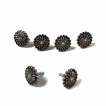 a collection of six ornate metal buttons with a blue center, arranged in two rows of three.