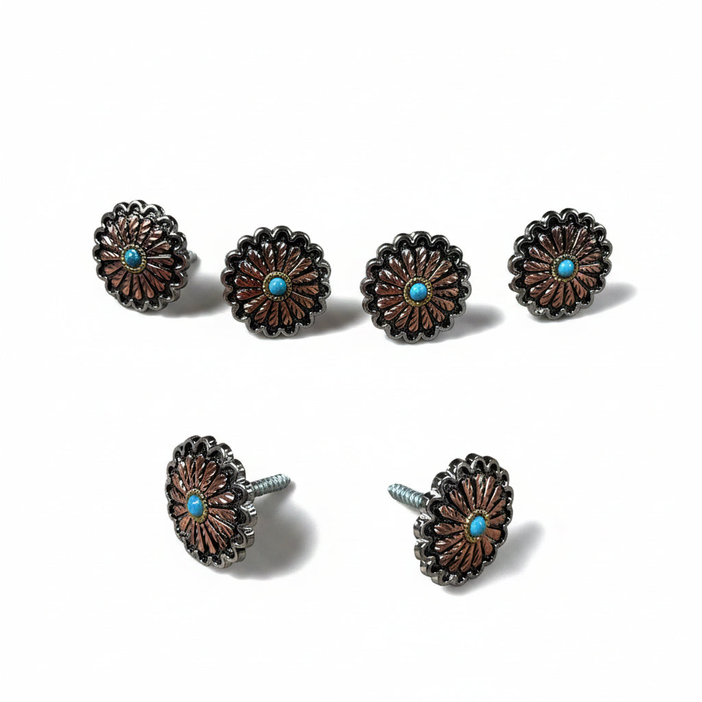 a collection of six ornate metal buttons with a blue center, arranged in two rows of three.