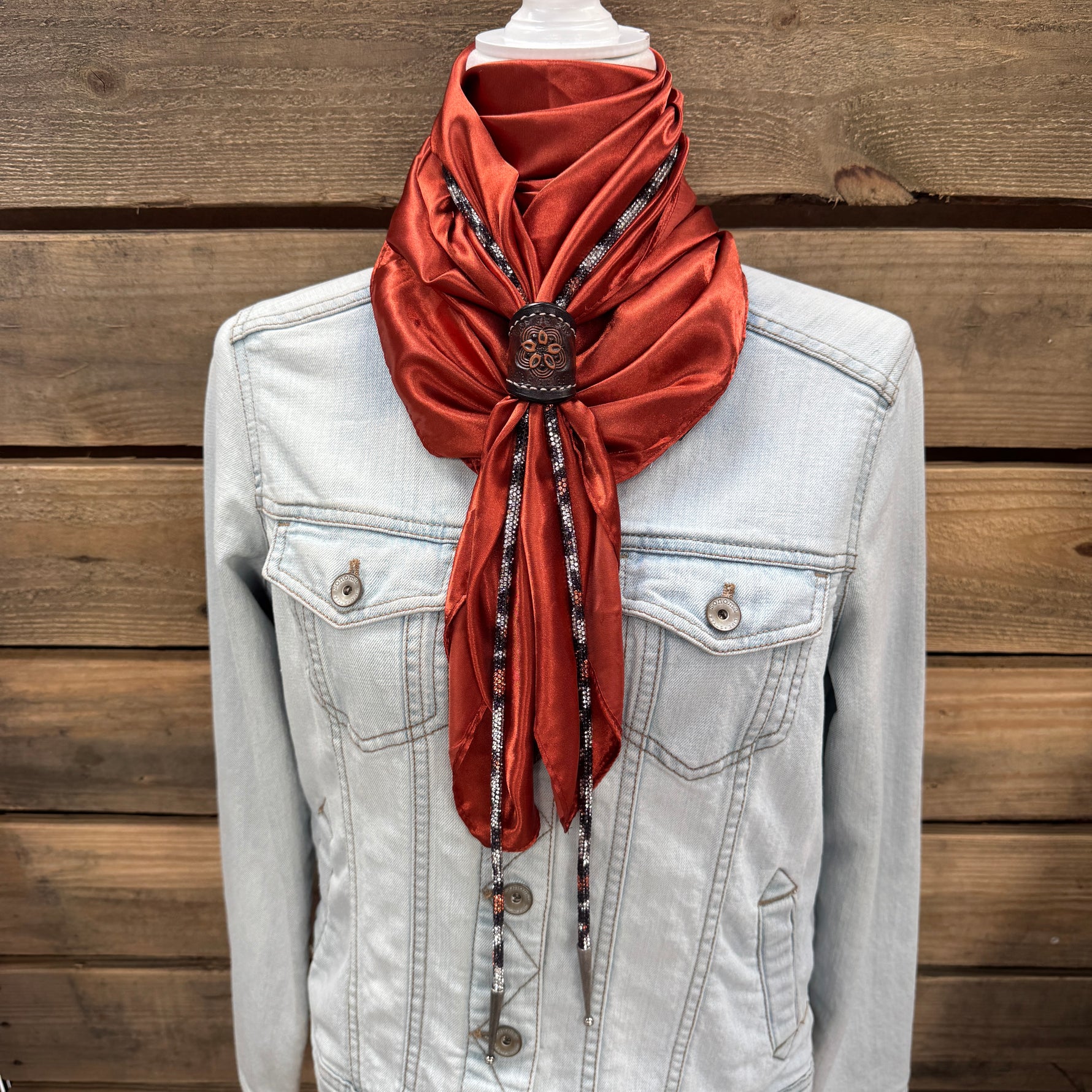 a white jacket and a red scarf on a mannequin
