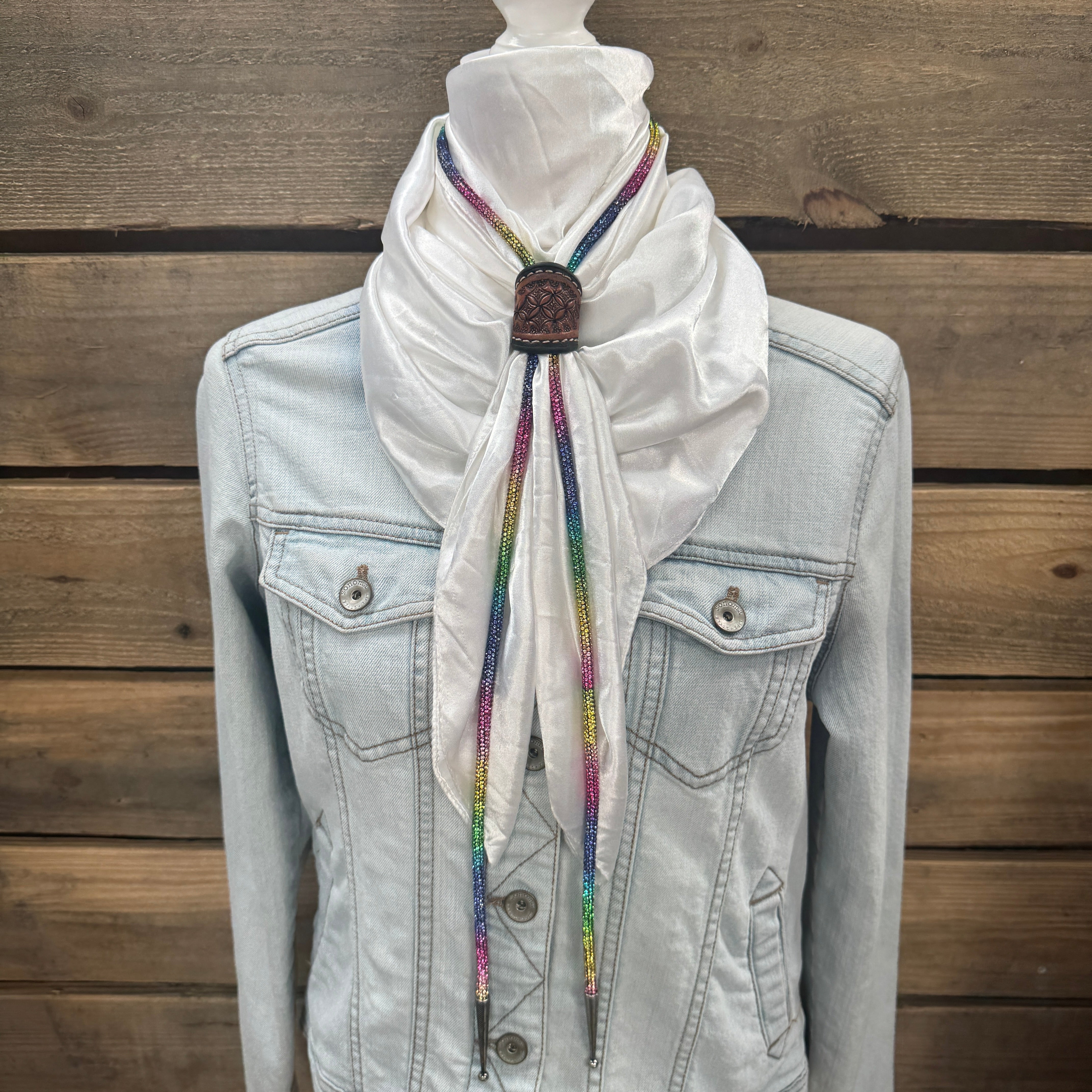 a denim jacket with a white scarf tied around it