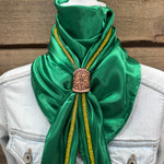 a woman wearing a green scarf and a white jacket