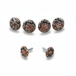a collection of ornate, circular metal pieces with intricate designs and patterns, including some with a metallic finish and others with a copper-like appearance.