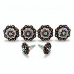 a pair of ornate, black-and-brown decorative knobs with sparkling rhinestones or crystals set in a circular pattern.