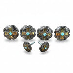 a collection of ornate metal buttons or knobs, each adorned with intricate designs and turquoise stones. The buttons are arranged in a row, showcasing their unique and decorative features.