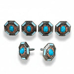 a collection of ornate, turquoise-colored knobs or buttons with intricate designs, arranged in two rows.