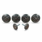 a collection of ornate, circular knobs or handles with intricate designs, arranged in a row.
