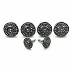 a collection of ornate, circular knobs or handles with intricate designs, including sunburst patterns and floral motifs, arranged in a row.