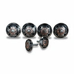 a collection of six round metal knobs or buttons, each with a unique design and color. The knobs are arranged in a row, with some of them appearing to be attached to a larger circular object. The image does not contain any text or additional objects, and the focus is solely on the knobs and their arrangement.