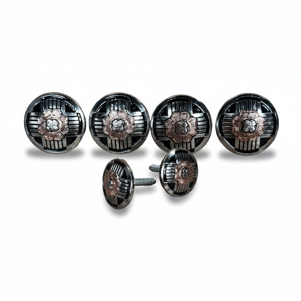 a collection of six round metal knobs or buttons, each with a unique design and color. The knobs are arranged in a row, with some of them appearing to be attached to a larger circular object. The image does not contain any text or additional objects, and the focus is solely on the knobs and their arrangement.