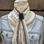 a white scarf tied to a jacket on a mannequin