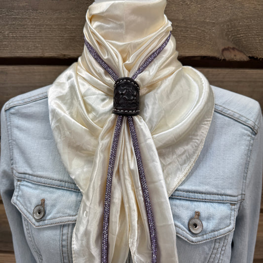 a white scarf tied to a jacket on a mannequin