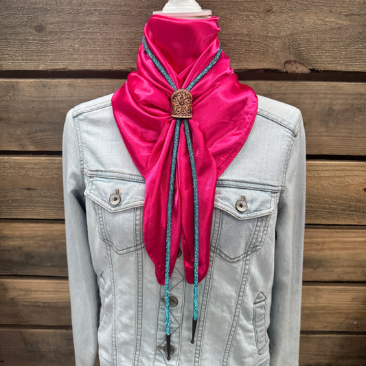 a pink scarf tied to a jacket on a mannequin