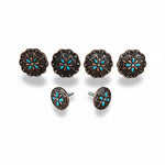 a collection of ornate, decorative knobs or buttons with intricate floral designs and turquoise accents.