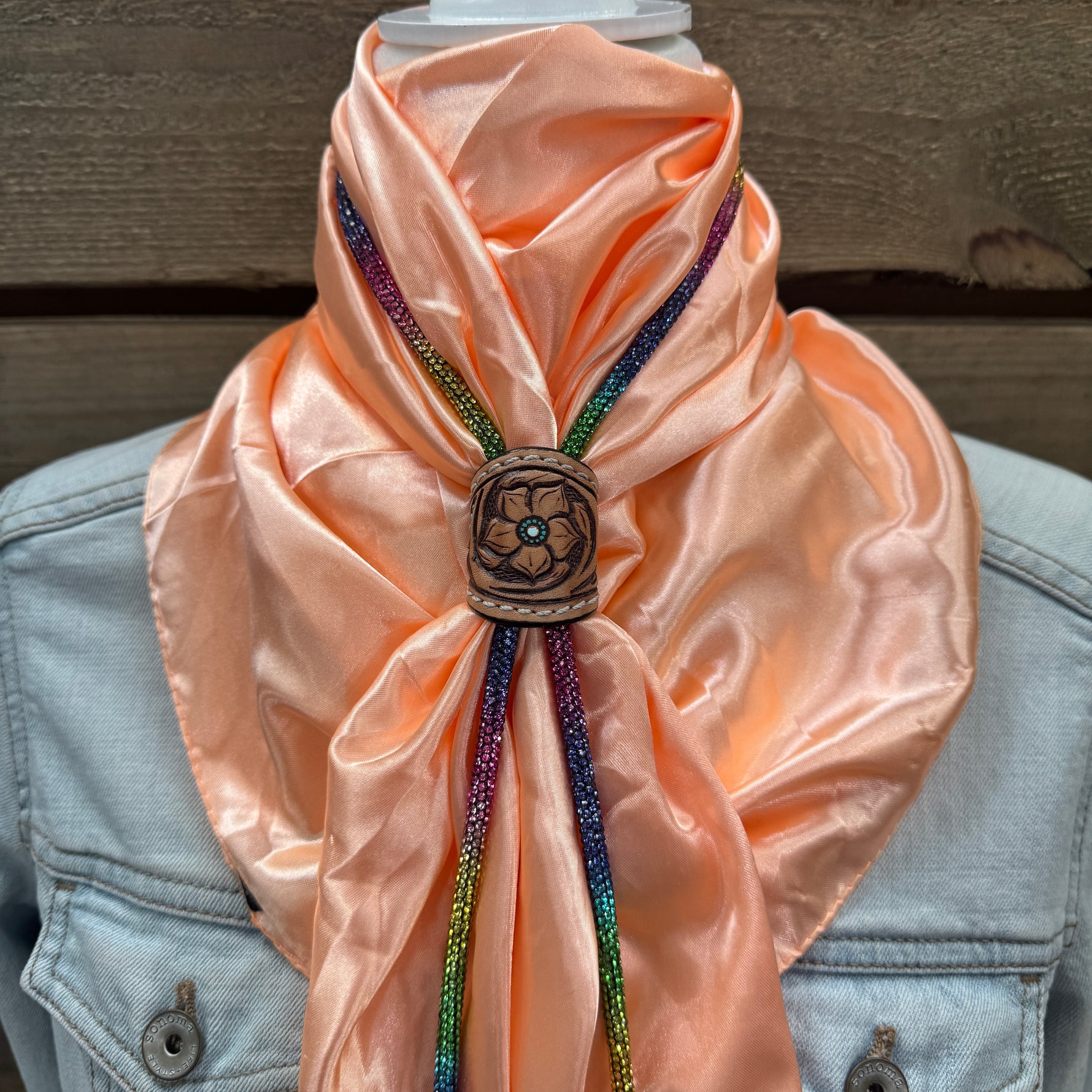 a woman wearing a pink scarf and a blue jacket