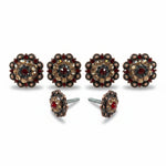 a pair of ornate, decorative knobs or handles with a floral design and embellished with gemstones or jewels.