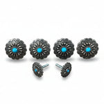 a collection of ornate silver knobs or handles with blue stones, arranged in a row.