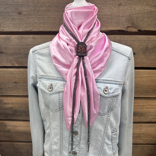 a pink scarf tied to a jacket on a mannequin