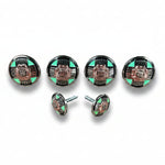 a collection of six round, metallic buttons with a floral design, arranged in two rows of three.