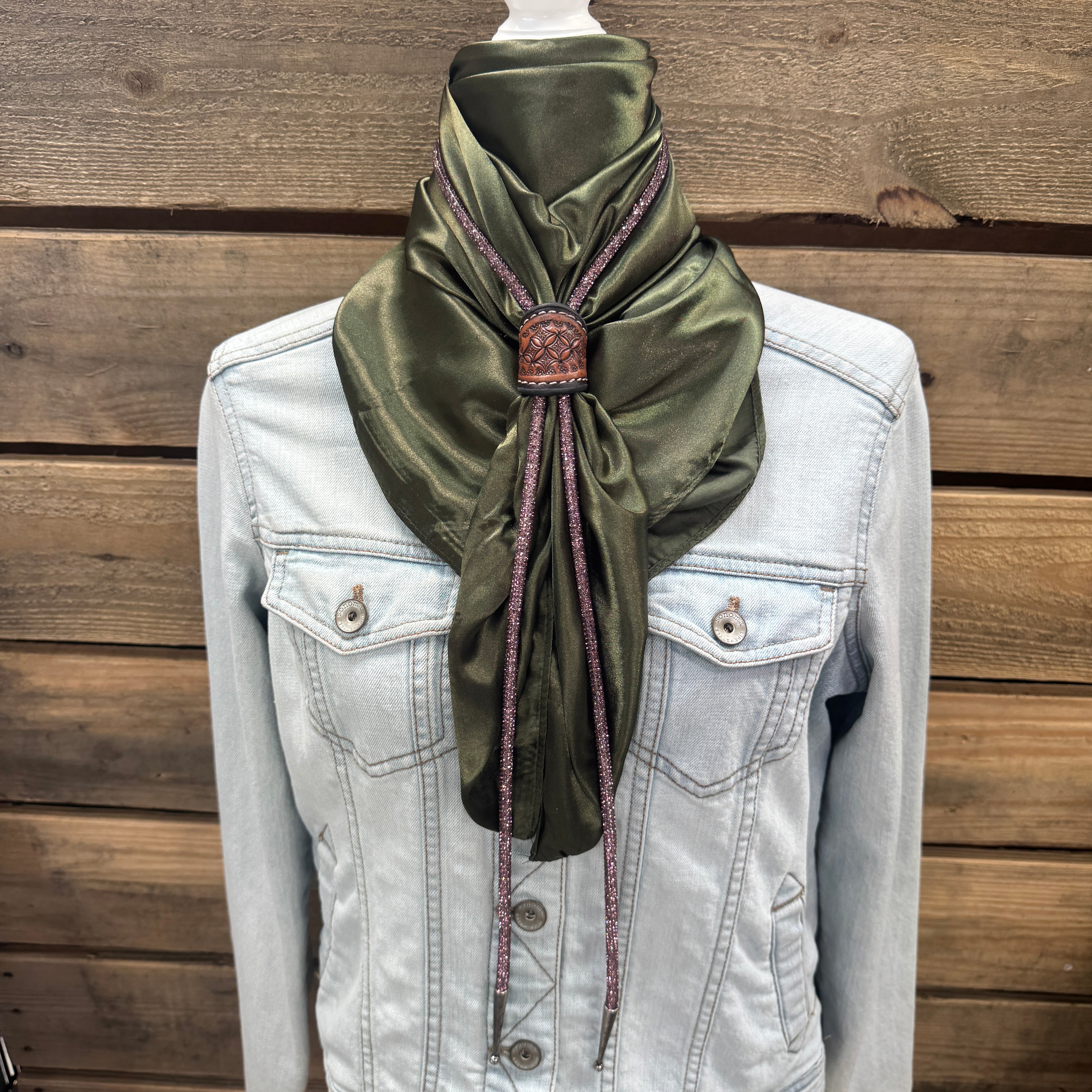 a white jacket and a green scarf on a mannequin