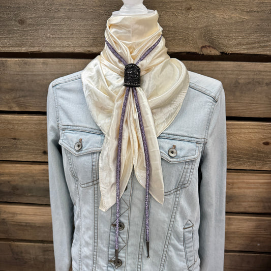 a white scarf tied to a jacket on a mannequin