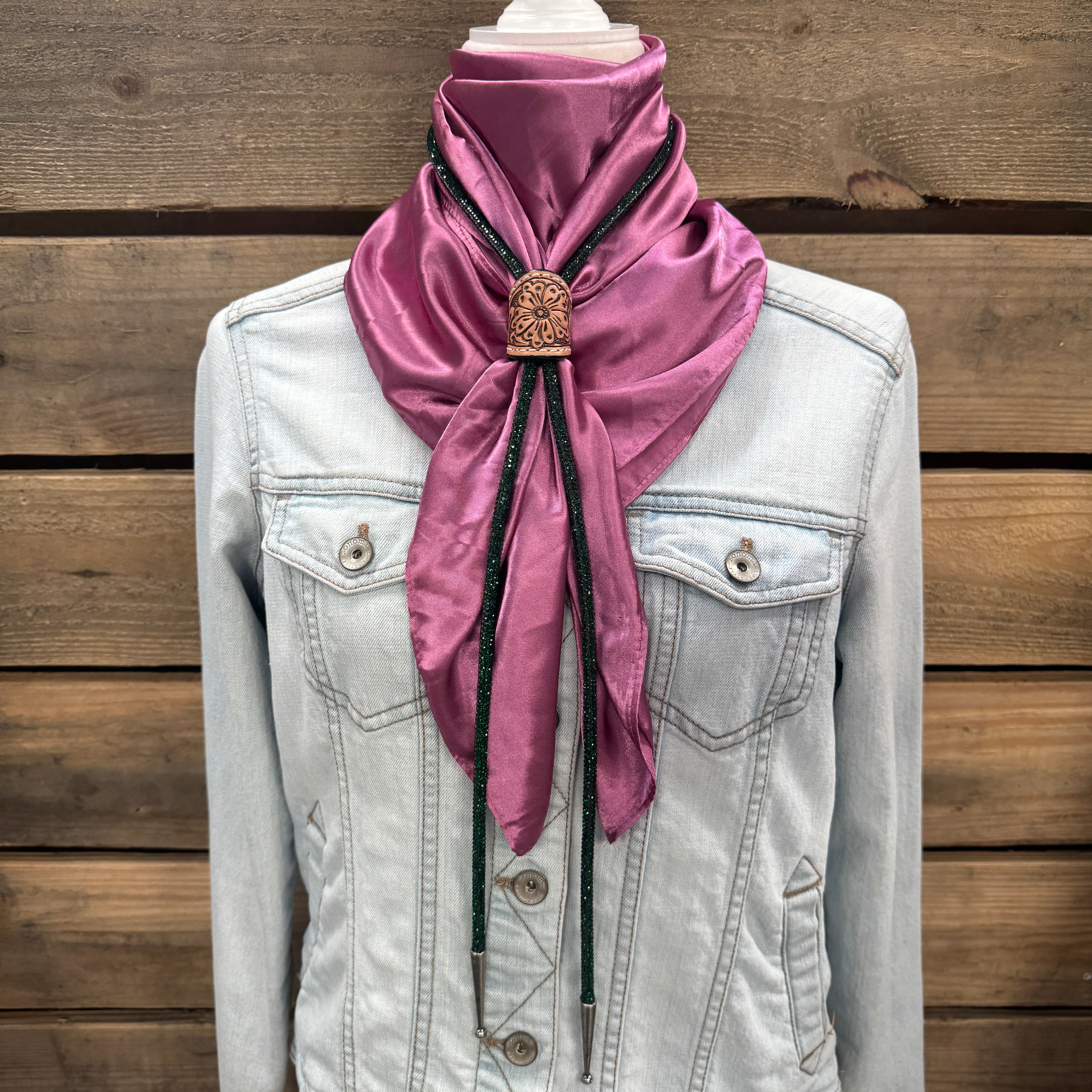 a white jacket with a pink scarf on top of it