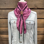 a white jacket with a pink scarf on top of it