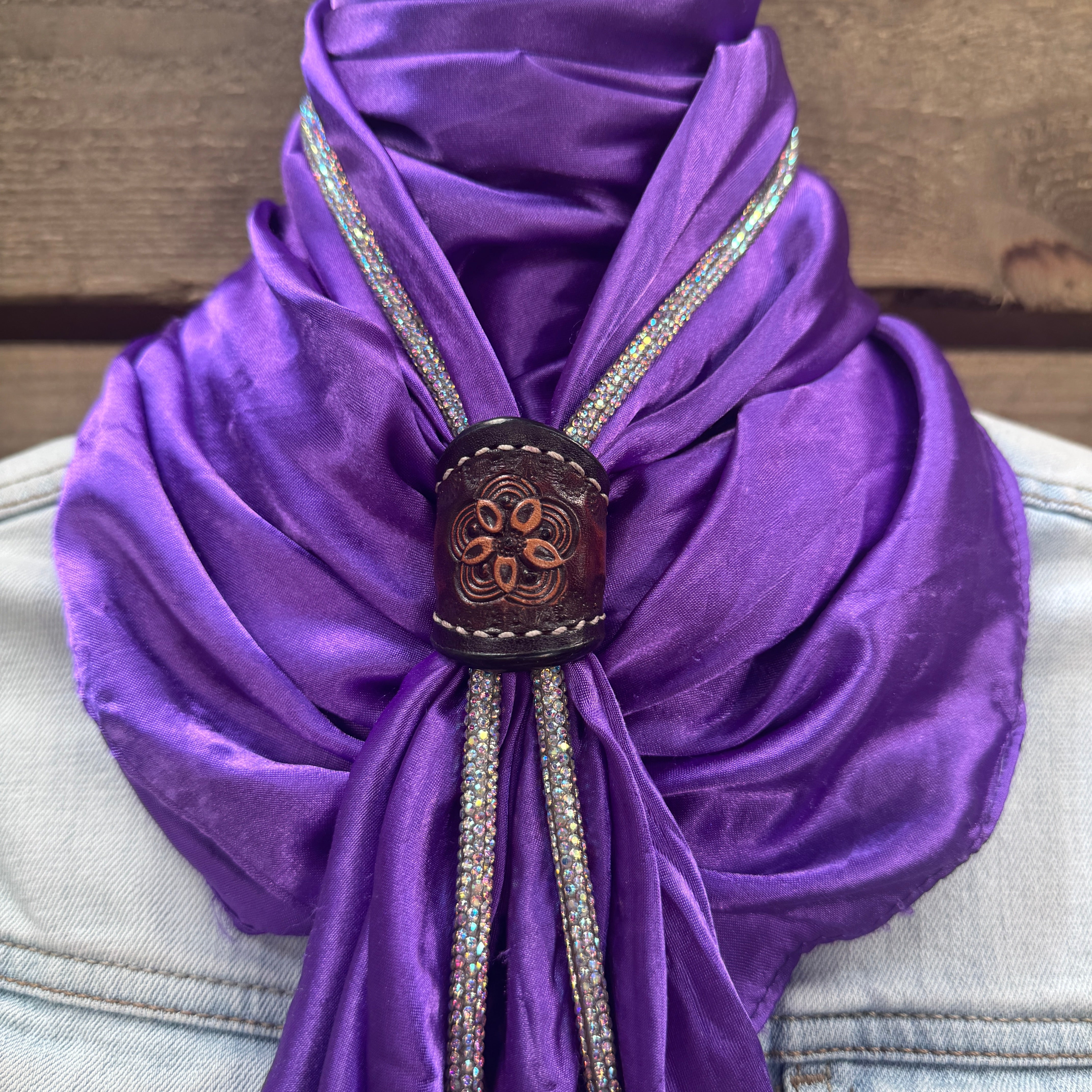 a purple scarf with a wooden buckle on it