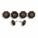 a collection of ornate, decorative buttons and knobs with intricate designs and embellishments, including gemstones and metallic elements.