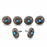 a collection of six ornate metal buttons with blue stones, arranged in two rows of three.