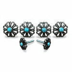 a pair of black metal flower-shaped knobs with turquoise stones set in the center.