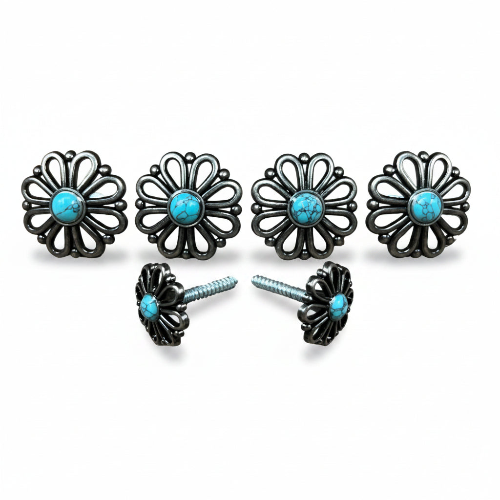 a pair of black metal flower-shaped knobs with turquoise stones set in the center.