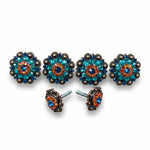 a pair of ornate, colorful buttons with blue and orange gemstones, as well as two screws that can be used to attach the buttons to a surface.