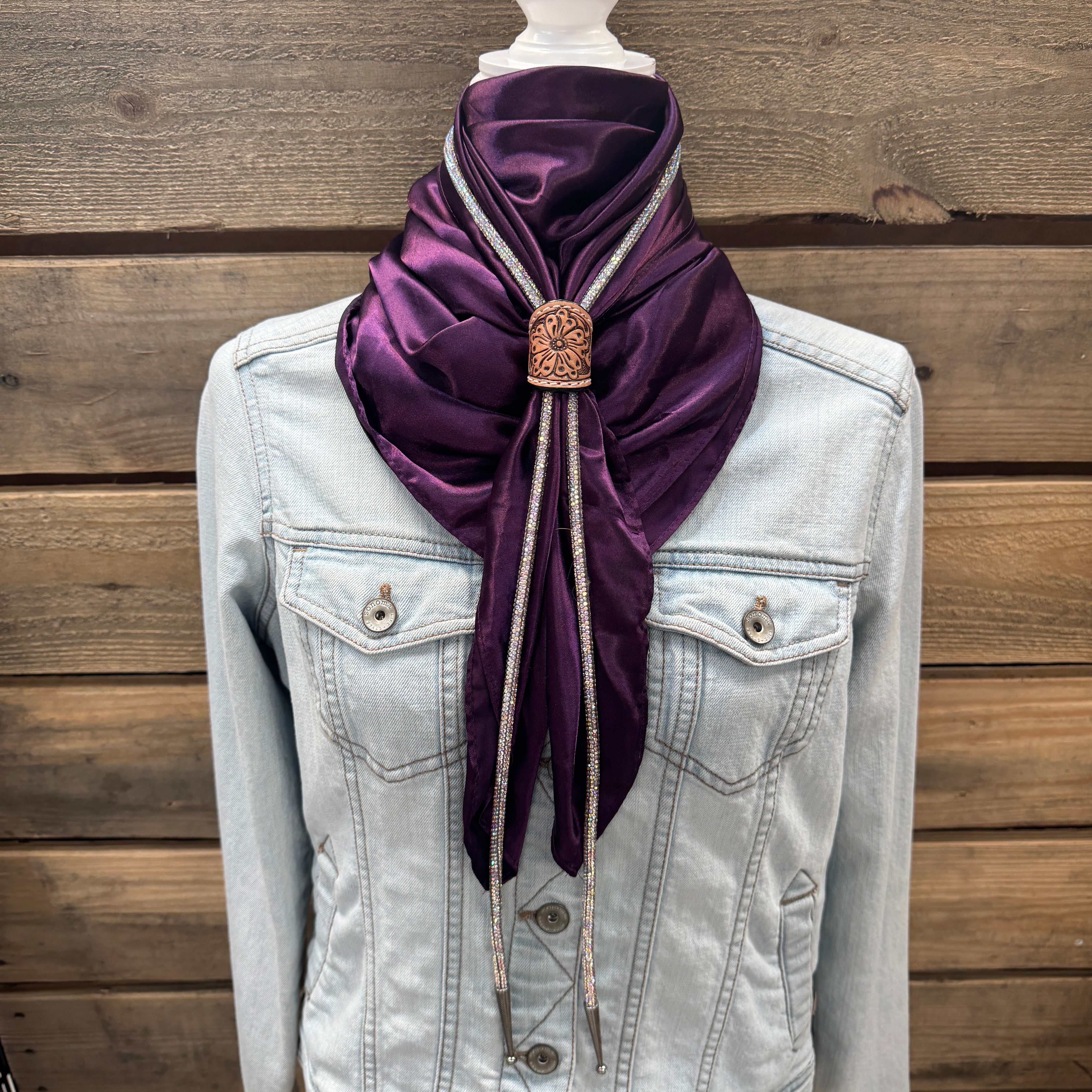 a white jacket with a purple scarf on top of it