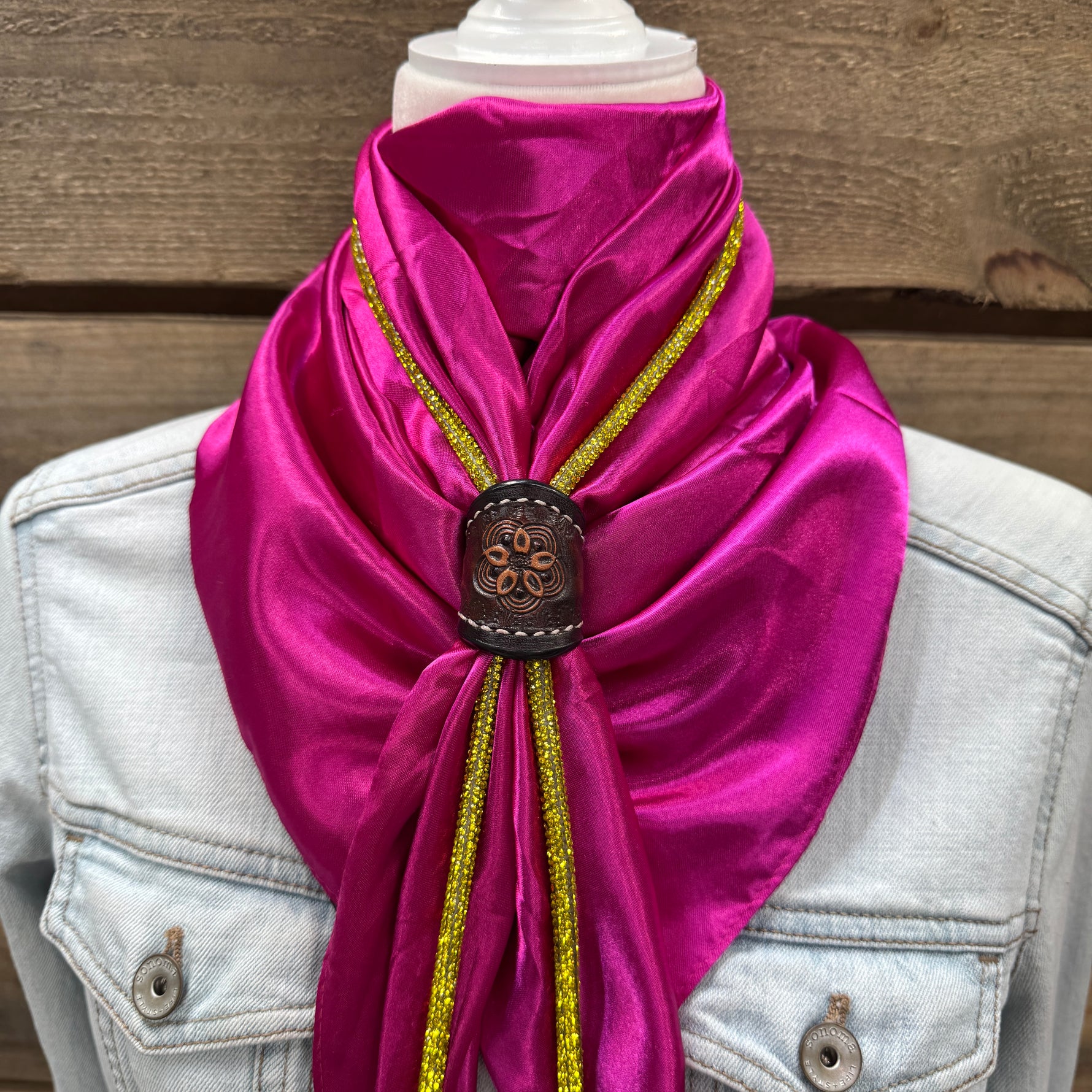 a woman wearing a pink scarf with gold sequins