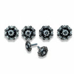 a collection of ornate, black and silver decorative buttons with intricate floral designs.
