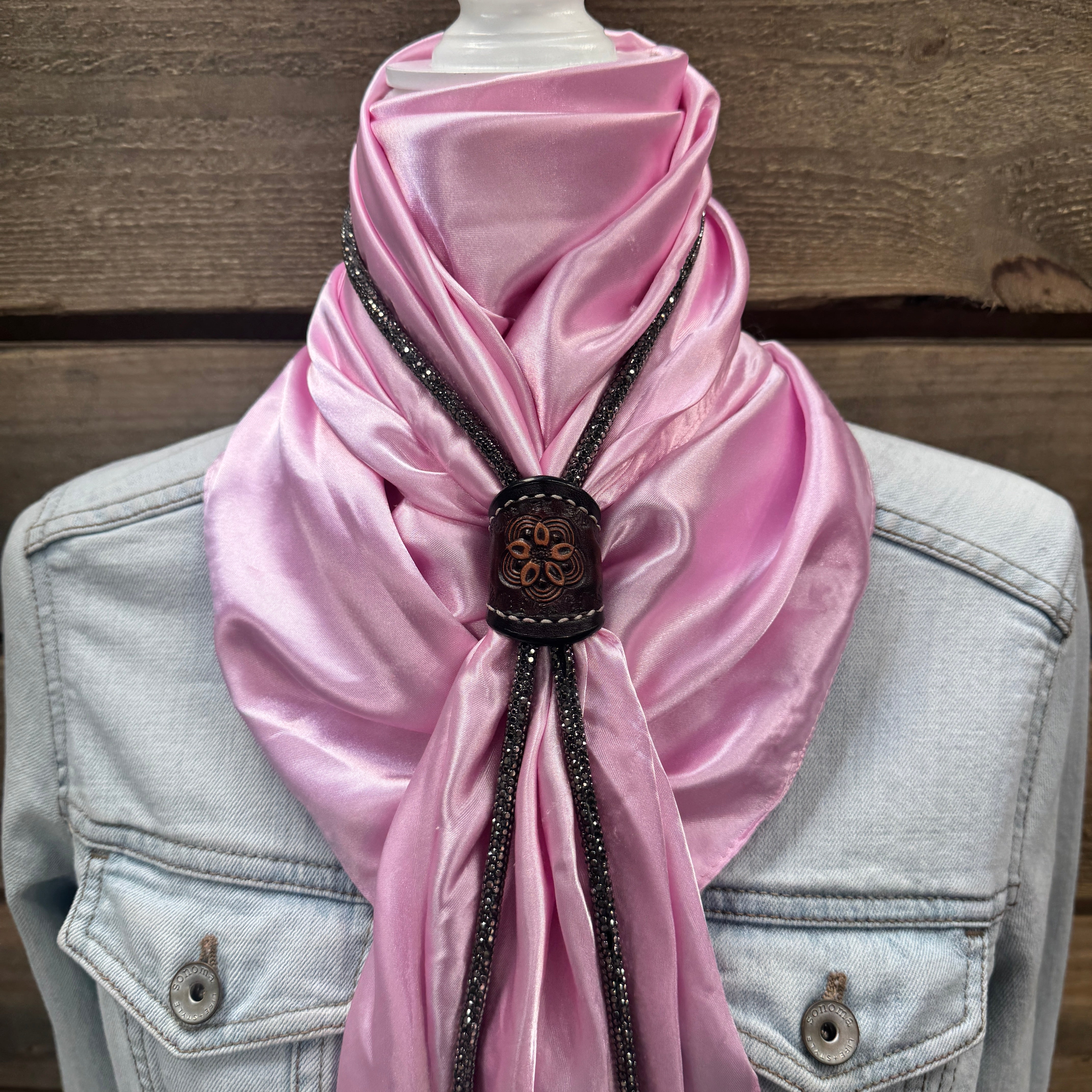 a pink scarf on a mannequin head