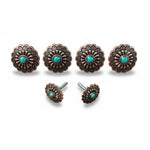 a collection of ornate, decorative metal pieces with turquoise stones, including knobs and handles, arranged in a row.