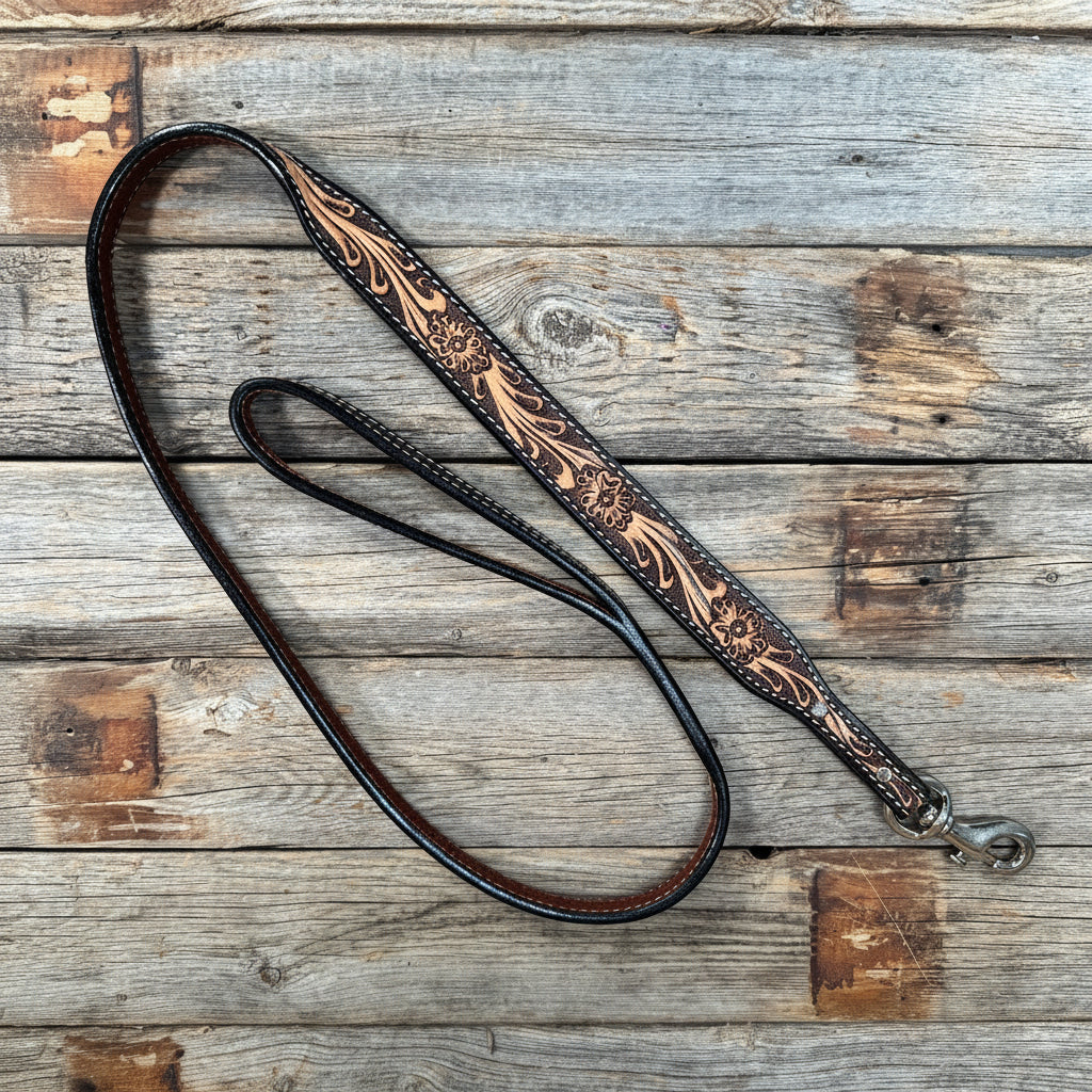 Decorative leather dog leash with intricate patterns on a wooden surface