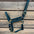 
hunter green 
horse halter with brass hardware on a wooden background