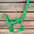 Green horse halter with brass hardware on a wooden background