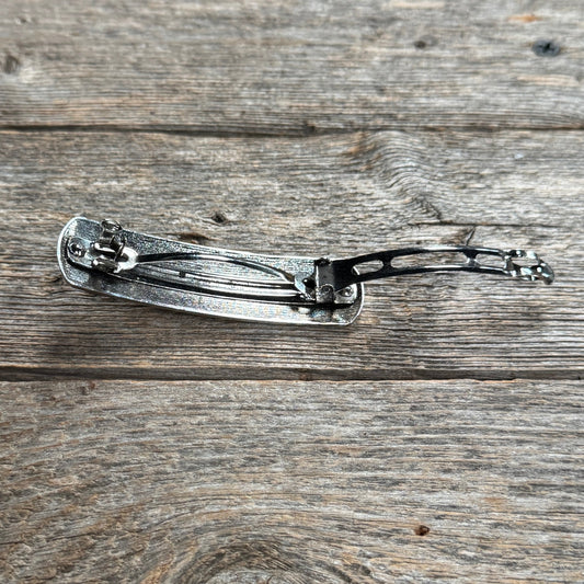 Decorative hair accessory back clip on a wooden surface | rodeo drive conchos | 